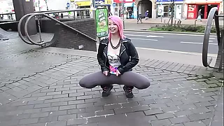 Beautiful and very slutty floozy shows her ass in public while pissing between her legs